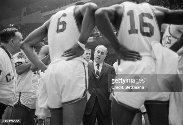 Celtics' coach Red Auerbach is dwarfed by his charges as he talks to them during time-out, 4th quarter, 1st game, NBA Eastern Division Final...