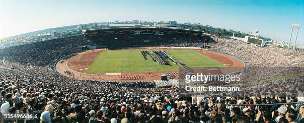 More than 80,000 spectators pack Tokyo's National Stadium for opening ceremonies of the XVIII Olympiad.