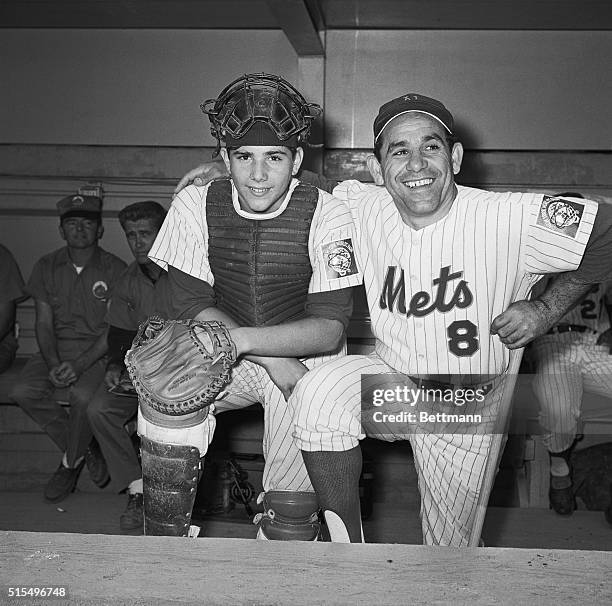 New York Mets coach Yogi Berra does the like-father-like-son bit with his boy, Lawrence after the youngster caught batting practice for Mets at Shea...