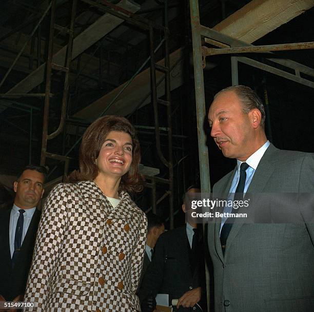 Jacqueline Kennedy and Robert W. Sarnoff, president of the National Broadcasting Company, view the unfinished Whitney Museum of American Art, October...