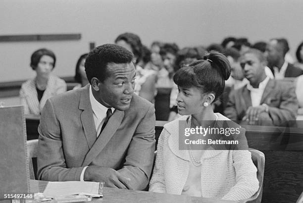 Cleveland Browns' fullback Jim Brown talks with his wife Sue during a court recess in which Brown is on trial for allegedly beating an 18-year-old...