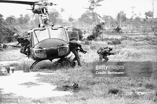 Troops of the US 173rd Airborne Division leap from a hovering helicopter in a landing zone, June 28, as a three-nation combat task force of Americans...