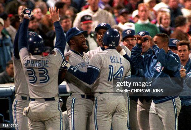 Toronto Blue Jays pinch hitter Ed Sprague is congratulated 18 October, 1992 in Atalnta, GA by teammates after he hit a two-run homerun in the eigth...