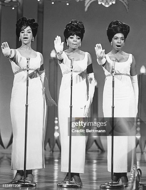 The Supremes singing in concert, from left: Florence Ballard, Diana Ross, and Mary Wilson, circa 1965.