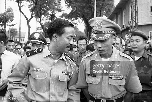 Head of the new military junta government in South Viet Nam, Air Vice Marshal Nguyen Cao Ky confers with his newly-appointed Defense Secretary, Army...