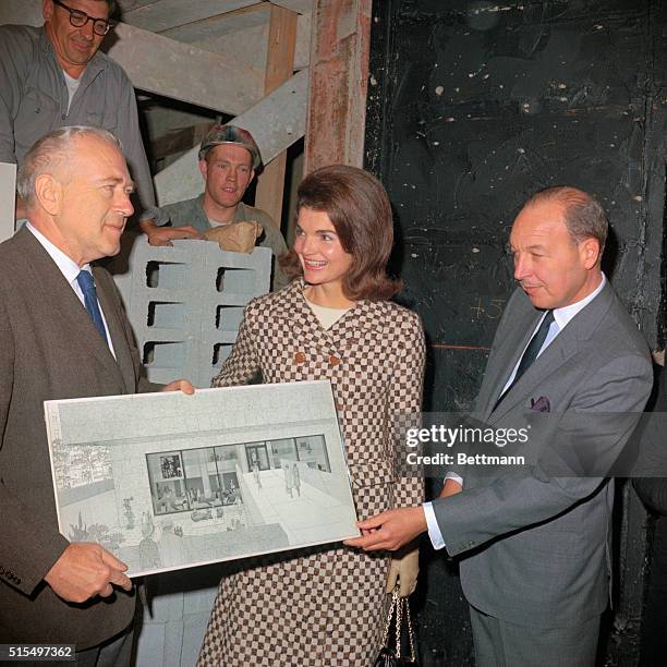 Jacqueline Kennedy and Robert W. Sarnoff , president of the National Broadcasting Company, look at a sketch today, October 21st, of the Whitney...