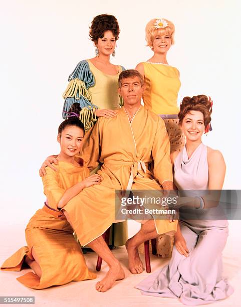 Actor James Coburn surrounded by , actresses Shelby Grant, Sigrid Valdis, Gianna Serra, and Helen Funai. All are appearing in the movie, Our Man...