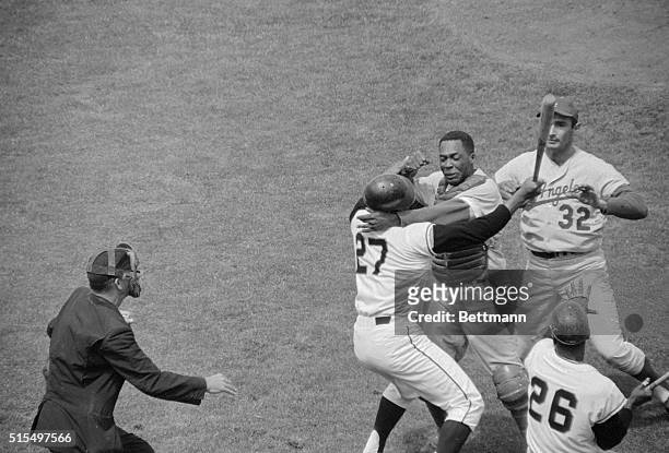 Los Angeles Dodgers' catcher John Roseboro suffered a cut on top of his head in 3rd inning during a bat swinging fight with San Francisco Giant...