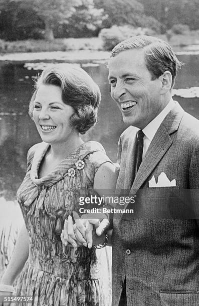 Happy Couple. Amsterdam, Netherlands: Strolling arm-in-arm and hand-in-hand. Crown Princess Beatrix and her fiance, Claus Von Amsberg smile at...