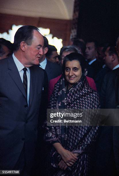 New Delhi, India: Vice President Hubert Humphrey makes a comment to a smiling Mrs. Indira Gandhi, Prime Minister of India, as he arrives for talks...