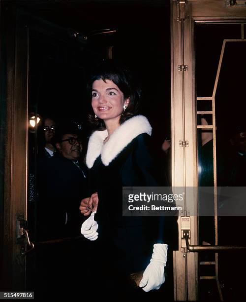 Jacqueline Kennedy and her escort Alan Jay Lerner arrive at the Mark Hellinger Theater for a performance of On a Clear Day You Can See Forever. She...