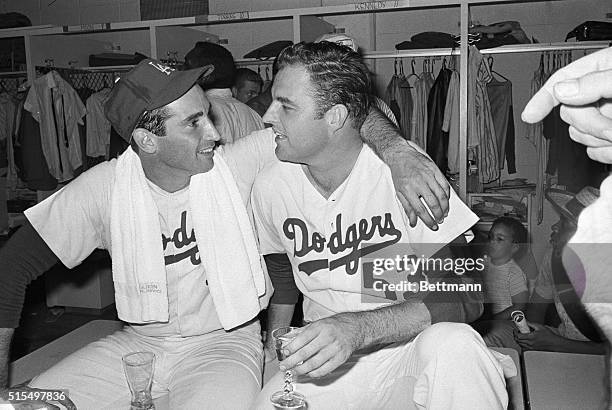 Dodger pitcher Don Drysdale congratulates Sandy Koufax in the dressing room after Sandy pitched the Dodgers to the National League Championship,...