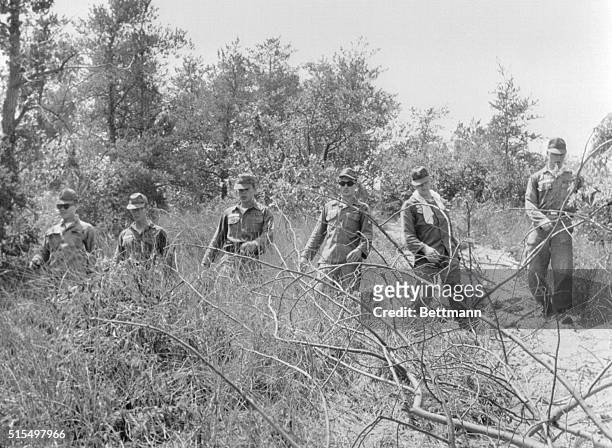 Soldiers from a military camp in Porter County in Indiana searching brush in the vicinity of Indiana Dunes State Park where 3 young women disappeared...