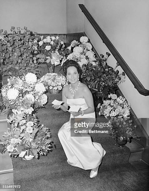 Best Wishes to Merle. Hollywood: Merle Oberon sits among the numerous bouquets of flowers she received from well-wishers on her first day at the...