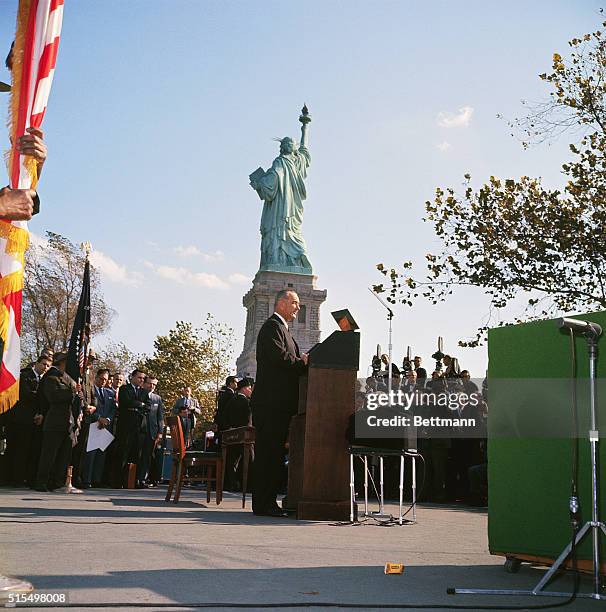 President Lyndon B. Johnson signed the new, liberalized, U.S. Immigration bill into law on Liberty Island, October 3rd. Here, with "Miss Liberty" in...