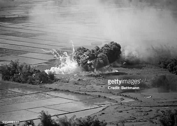 Napalm bomb, dropped on suspected Communist target, sends up billows of smoke after being released from a U.S. Air Force plane south of Da Nanag...