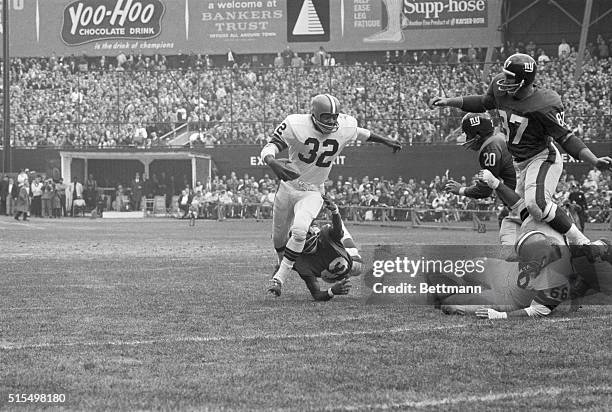 Cleveland Browns' Jim Brown is tackled by New York Giants' Carl Lockhart during first quarter of game at Yankee Stadium. Brown gained 12 yards on the...