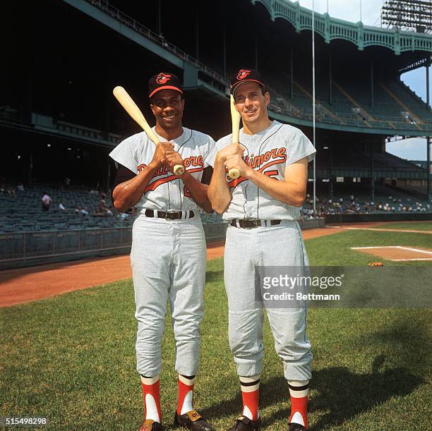 Baltimore Orioles Frank Robinson poses with Brooks Robinson at Yankee Stadium.