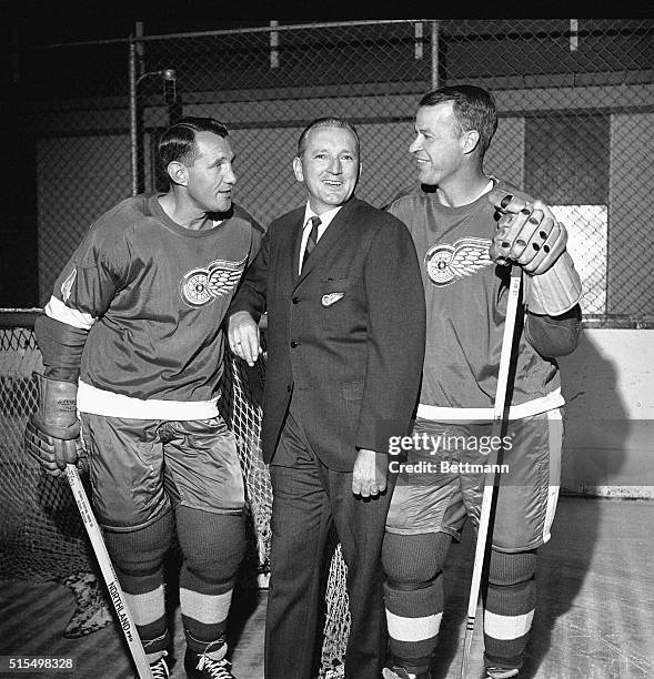 Red Wings' Coach Sid Abel talks with two of his veterans, Bill Gadby and Gordon Howe as the Red Wings opened their training camp here 9/23. The Red...