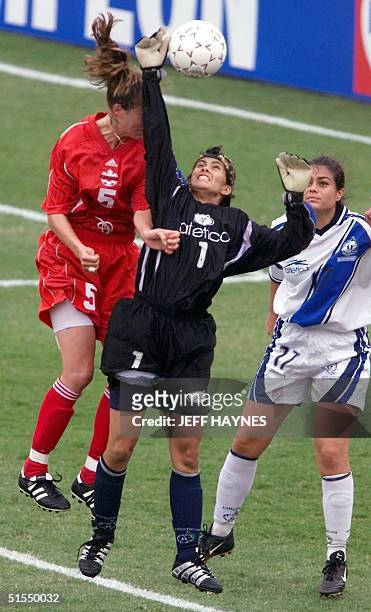 Andrea Neil of Canada fights Guatemala's goalie Susana De Leon for the ball as Linda Castillejos of Guatemala looks on 28 June 2000, in the first...