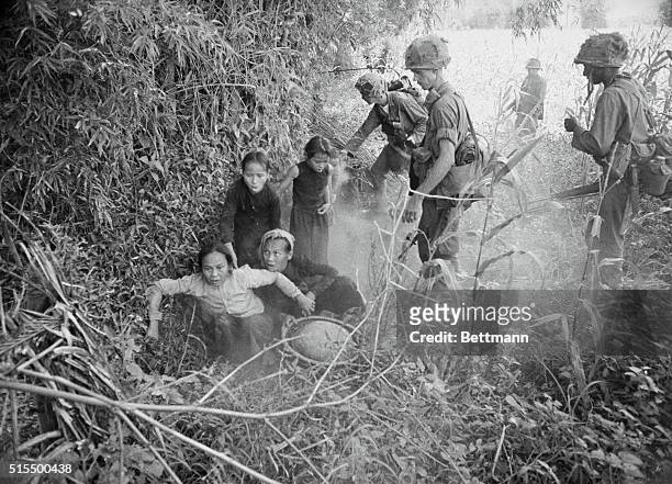 Thu Xuyn, S. Vietnam: Coughing Vietnamese women and children emerge from a hole which they had flushed by troopers of the 1st Cavalry using smoke and...