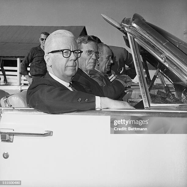 President Lyndon B. Johnson, at the wheel of his car, takes Treasury Secretary Henry Fowler and Federal Reserve Board Chairman William McChesney...