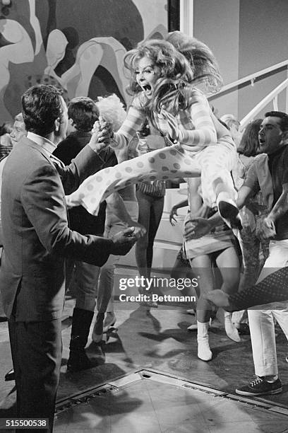 Actress Ann Margret provides the excitement as she goes wild in a dance sequence with Dean Martin in their newest Columbia Picture, "Murder's Row"....