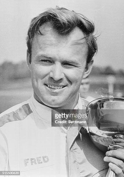 Smiling Fred Lorenzen holds up one of his trophies her October 17 after winning the National 400 auto race at the Charlotte Motor Speedway, Lorenzen...