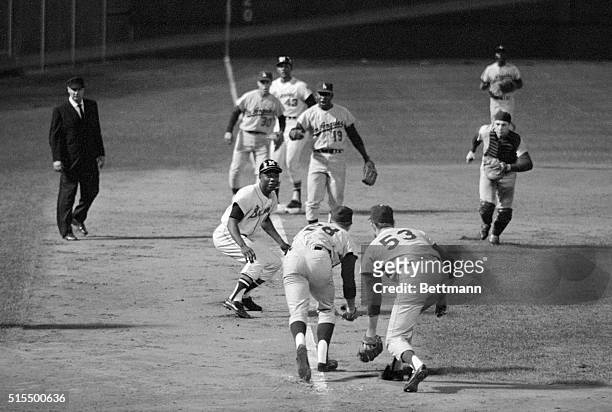 The third baseline was full of Los Angeles Dodgers as they tried to tag Milwaukee Braves right fielder Hank Aaron out in this photo, after he was...