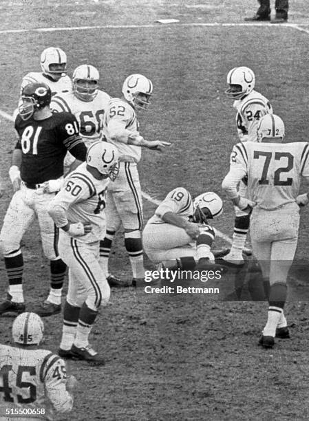 Johnny Unitas, Colt quarterback holds his leg in pain after being hurt in second quarter of game with Chicago Bears. Unitas tore ligaments in his...