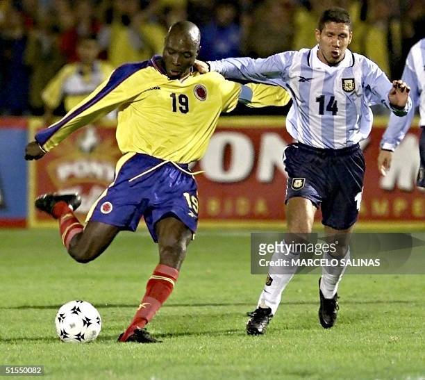 Freddy Rincon of Colombia kicks the ball in front of Diego Simeone during their elimination game in Bogota, Colombia 29 June, 2000. Freddy Rincon de...