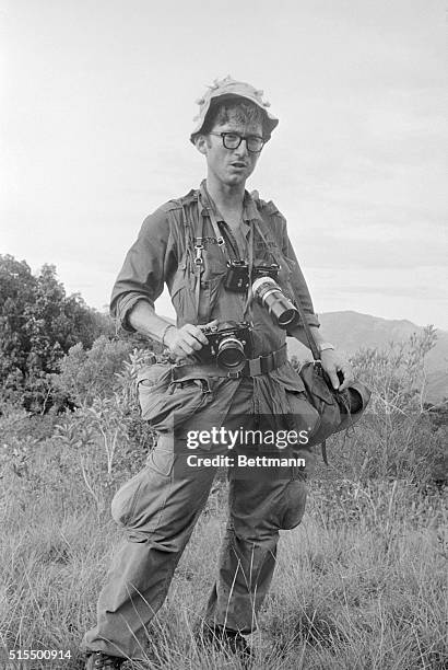 Dressed in fatigues and with cameras slung around his neck, UPI Staff Photographer Dana Stone moves out with a U. S. 1st Cavalry Division...