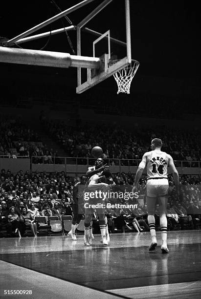 Los Angeles Lakers Elgin Baylor uses a little rough play to foul up a throw to the basket by St. Louis Hawks' Gene Tormohlen during the first period...