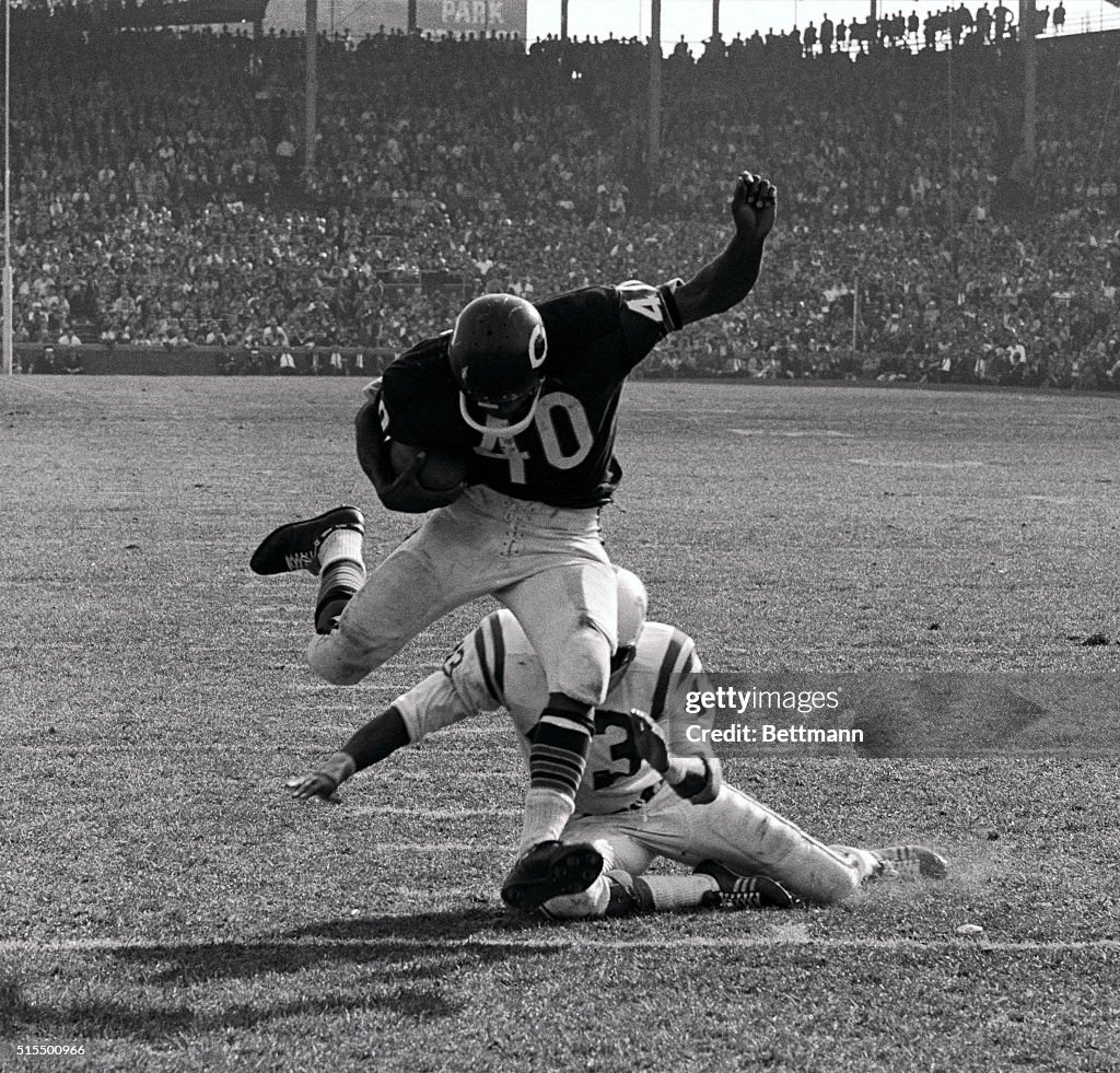 Gale Sayers Eluding Tackle During Football Game