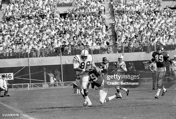 The Baltimore Colt's end John Mackey, gets away from a tackle by Minnesota Vikings Karl Kassulke, to score after taking a pass from Colts quarterback...