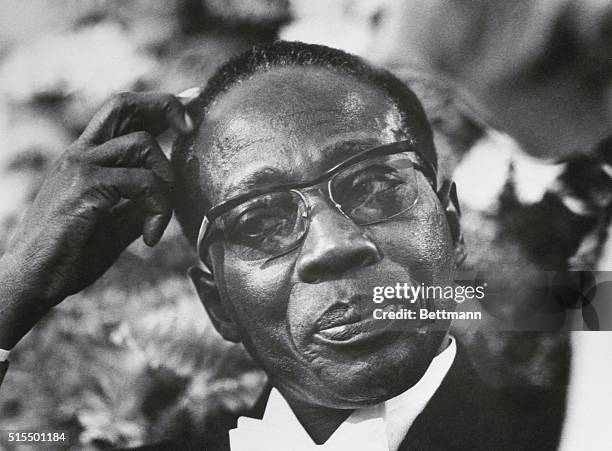 Ottawa, Canada: President Leopold Senghor of the Republic of Senegal seems puzzled as he talks with a guest at a reception held, September 19, at...