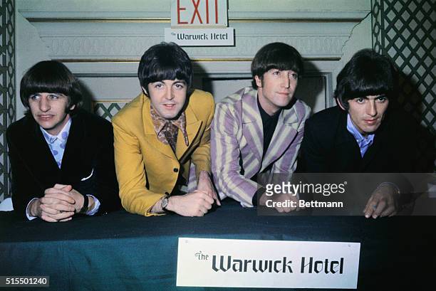 The Beatles are shown at a press conference at the Warwick Hotel. Standing left to right are: Ringo Starr, , Paul McCartney, John Lennon, and George...