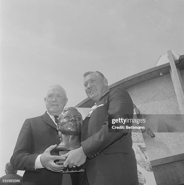 Clyde "Bulldog" Turner , is presented a bust of himself by Ed Healey, a football official, after Turner's induction in the National Professional...