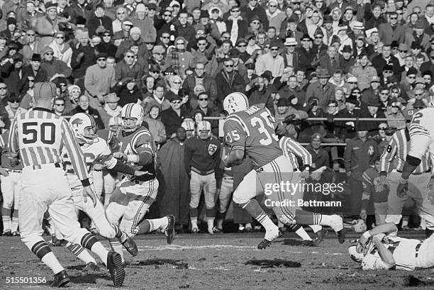 Boston Patriots fullback Jim Nance breaks away from Buffalo Bills' George Saimes as he goes sixty-five yards for the winning touchdown to lead Boston...