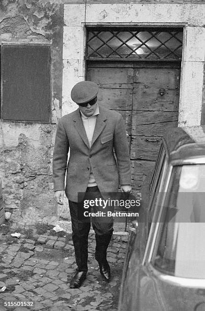 Actor Marlon Brando, notoriously camera-shy when he's not on a film set, leaves his quarters on an island in the middle of the Tiber River December...