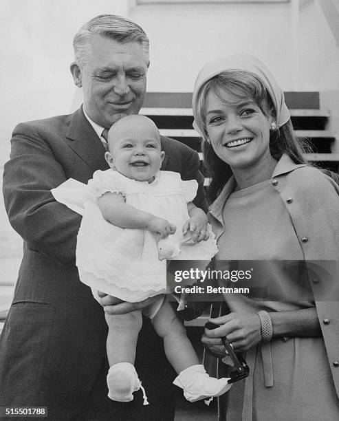 British-born Hollywood actor Cary Grant, his actress-wife, Dyan Cannon, and their seven-month old baby daughter, Jennifer, are shown aboard the P & O...