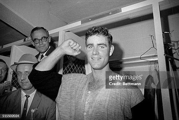 Baltimore pitcher Jim Palmer displays his strong right arm to newsmen following his 4-hit shutout which gives the Orioles a two-game lead in the 1966...