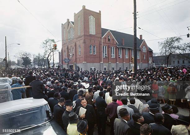 Thousands of funeral marchers gathered outside Ebenezer Baptist Church prepare to walk five miles to Morehouse College where another service for the...