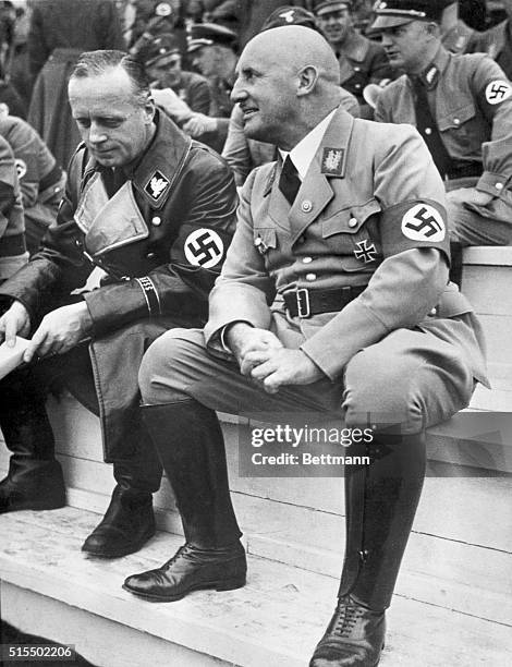 Julius Streicher and Joachim Von Ribbentrop sit side by side at a Nazi Ceremony. This photo was found in Streicher's personal files at his estate at...