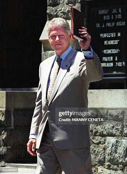 President Bill Clinton waves his Bible followinn a church service at Foundry United Methodist Church 09 July 2000 in Washington, DC. Clinton will be...