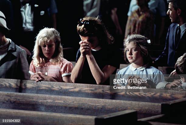 Mrs. John F. Kennedy and her children Caroline and John Jr., pray in Saint Patrick's Cathedral as the body of Sen. Robert F. Kennedy lies in State.