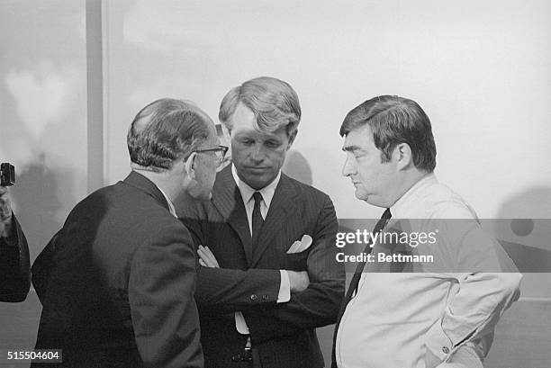 Sen. Robert Kennedy holds a private huddle with aide Fred Dutton and his press secretary Pierre Salinger while waiting out the results of the...