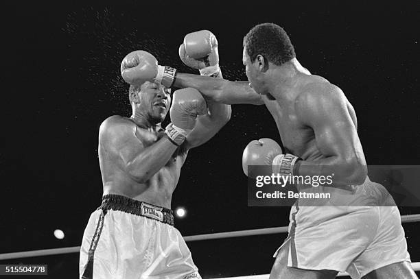 Tim Weatherspoon takes a hard punch from WBC World Heavyweight Champion Larry Holmes in round six of their 12 round title bout at the Dunes Hotel....