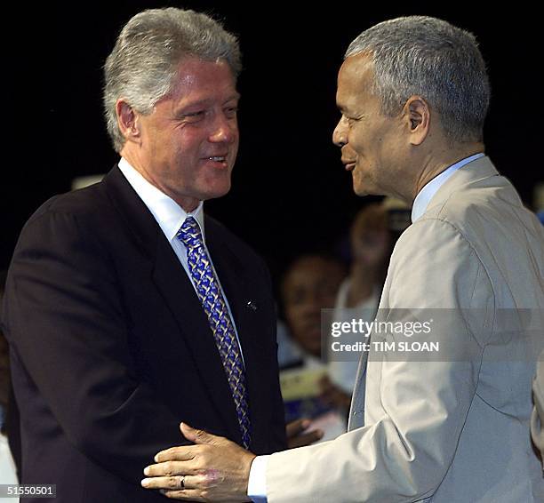 President Bill Clinton shakes hands with NAACP chairman Julian Bond at the 91st Convention of the National Association for the Advancement of Colored...