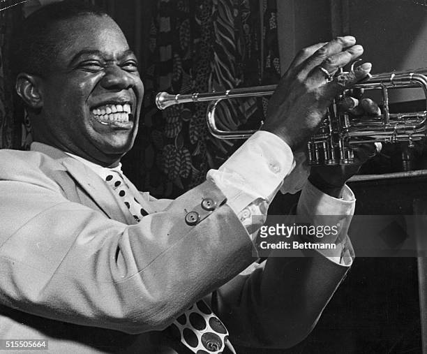 Louis Armstrong plays his trumpet during a performance in Baltimore.